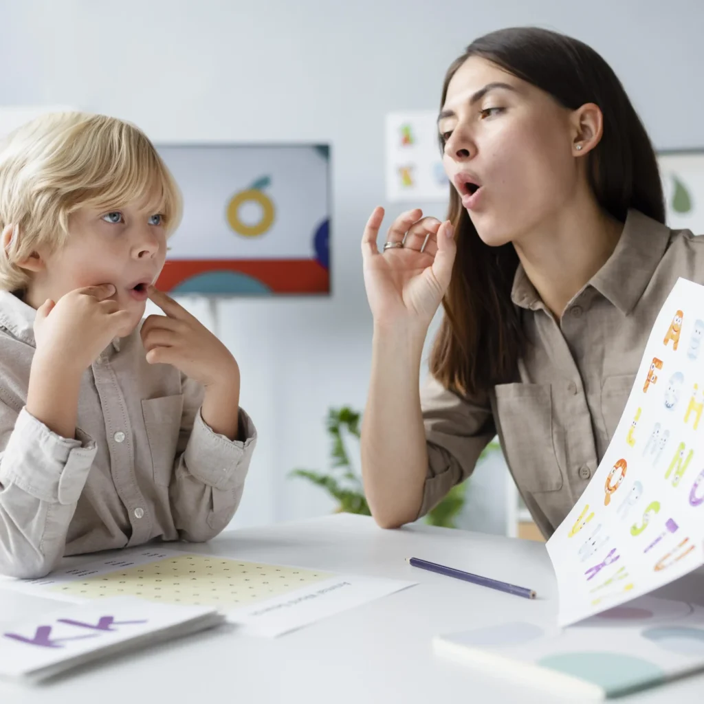 woman-doing-speech-therapy-with-little-blonde-boy